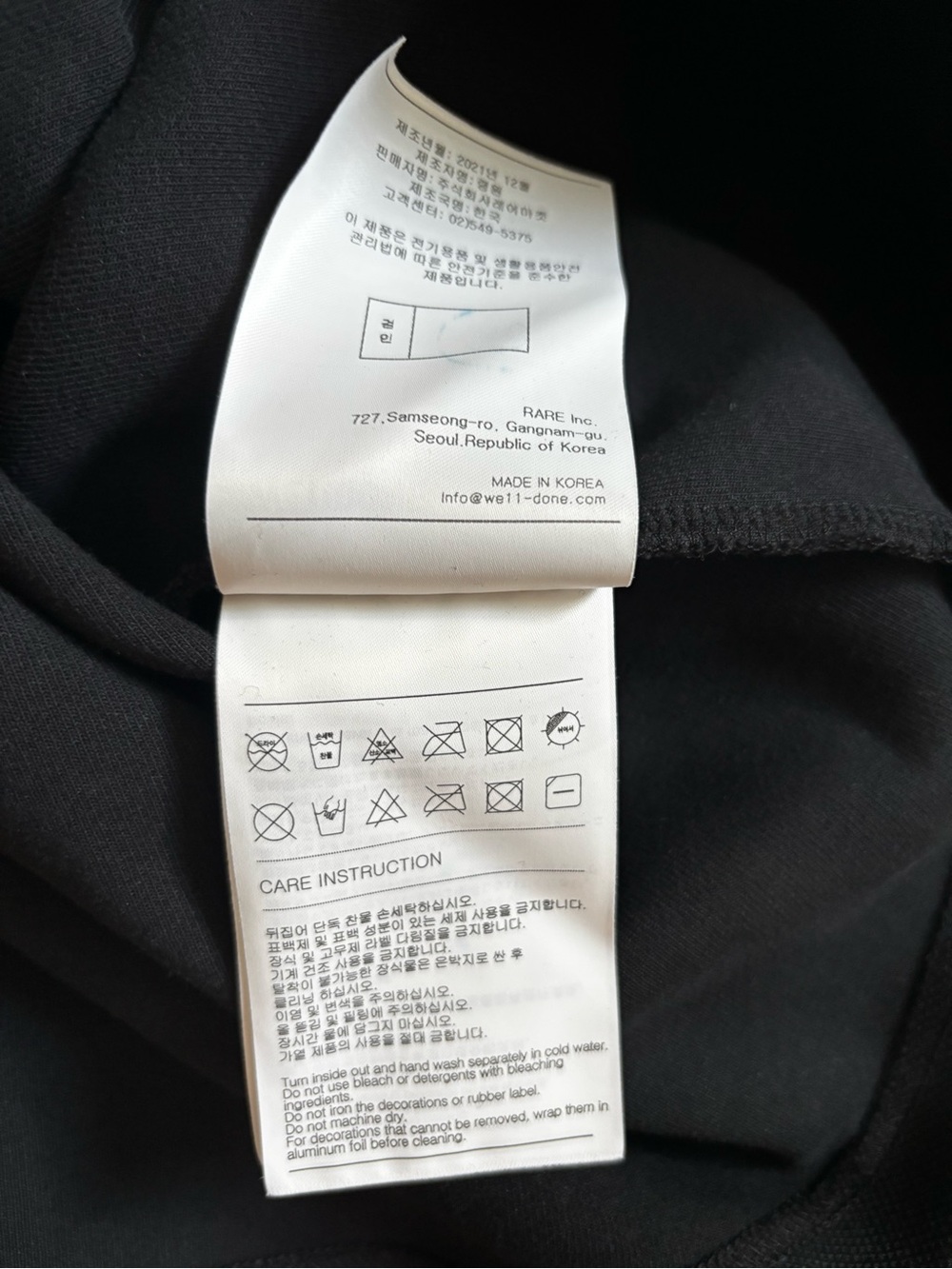 Men's Black V-Neck Sweater with White Geometric Accents - Picture 7 of 7